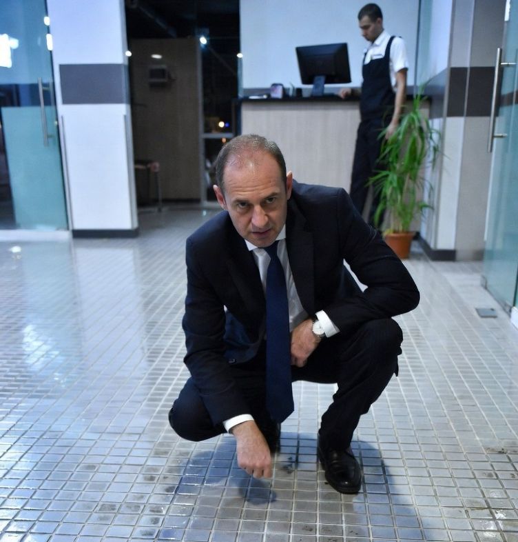 business owner inspecting tiles